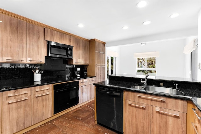 kitchen with black appliances, dark stone countertops, sink, and decorative backsplash