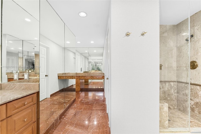 bathroom with vanity and a shower with shower door