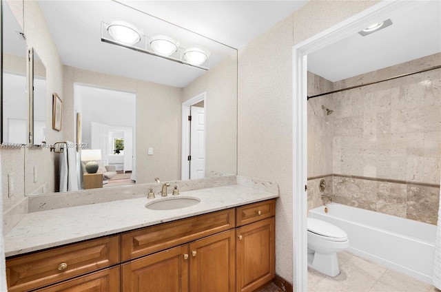 full bathroom featuring vanity, toilet, tiled shower / bath combo, and tile patterned floors