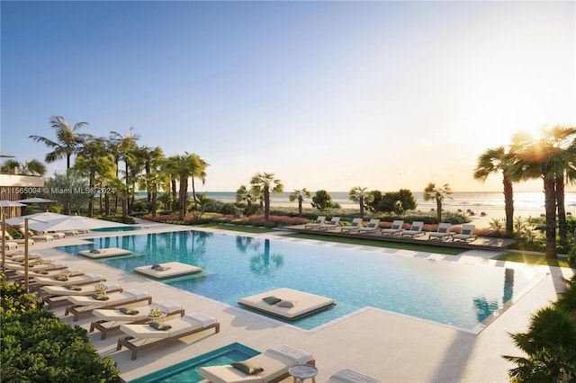 pool at dusk with a patio