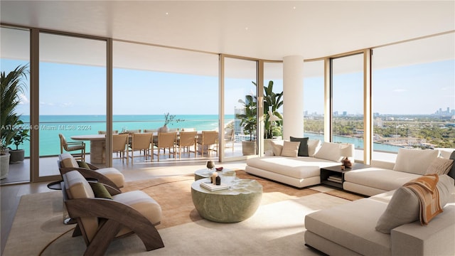 living room with floor to ceiling windows, a water view, and light wood-type flooring