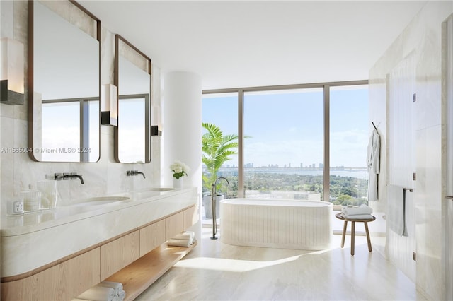 bathroom with tile walls, double vanity, and a wall of windows