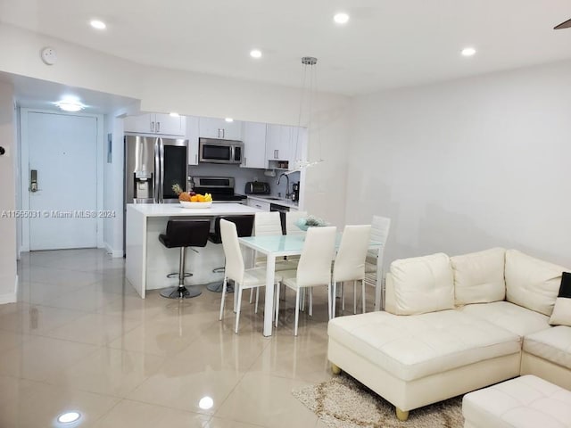 living room with sink and light tile floors