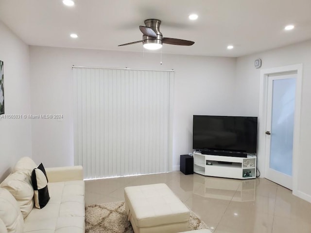 living room featuring ceiling fan and light tile flooring