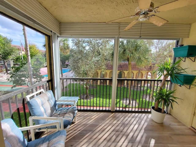 sunroom featuring ceiling fan