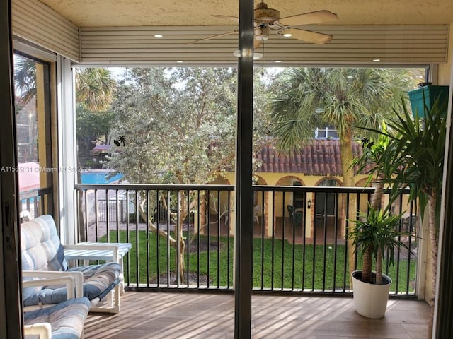 sunroom / solarium featuring ceiling fan and plenty of natural light