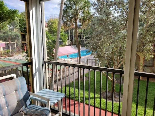 balcony with a fenced in pool