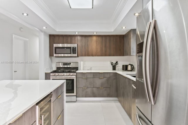 kitchen with stainless steel appliances, a raised ceiling, light tile floors, and wine cooler