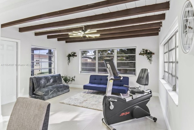 exercise room featuring a notable chandelier and light tile floors