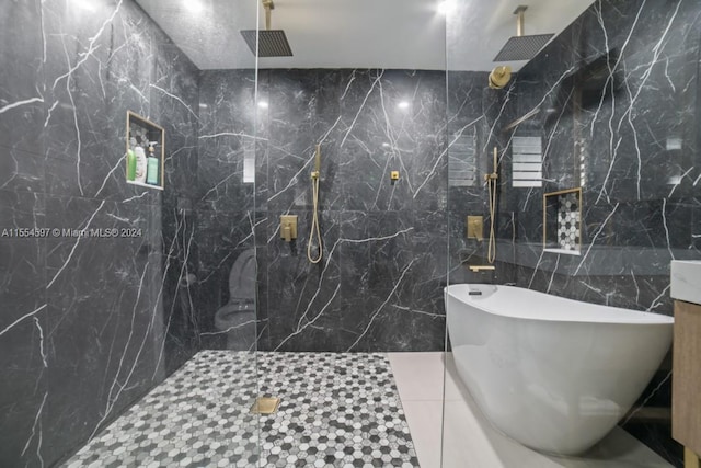 bathroom featuring tile flooring, tile walls, tiled shower, and vanity