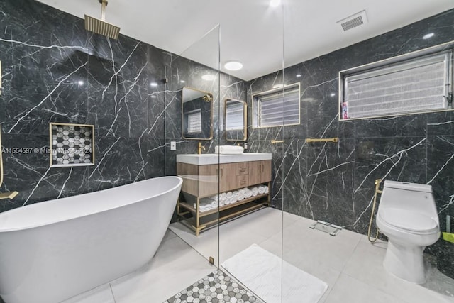 bathroom featuring tile walls, toilet, vanity, and tile flooring