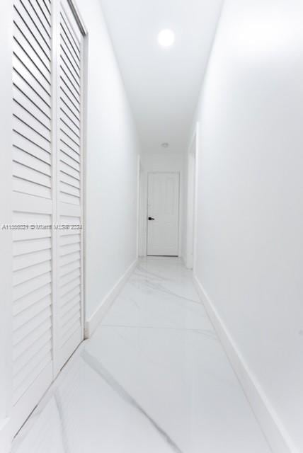 bathroom with tile patterned flooring, a shower with door, toilet, vanity, and tile walls