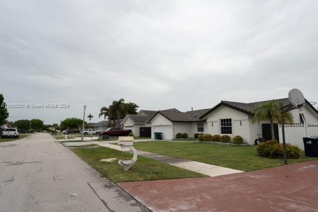 exterior space with a garage and a front lawn