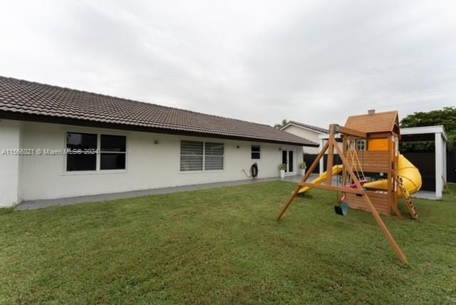 exterior space featuring a yard and a playground