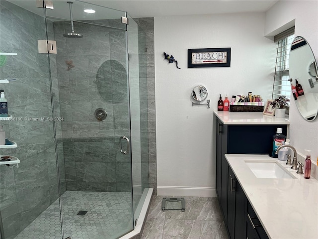 bathroom featuring tile floors, a shower with door, and vanity