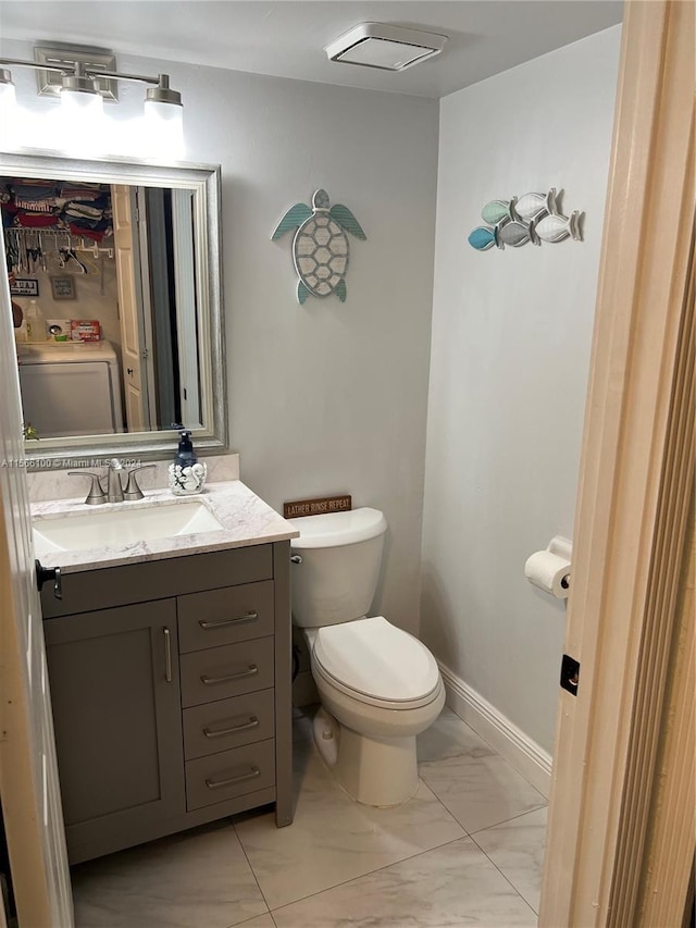 bathroom with tile flooring, vanity, and toilet