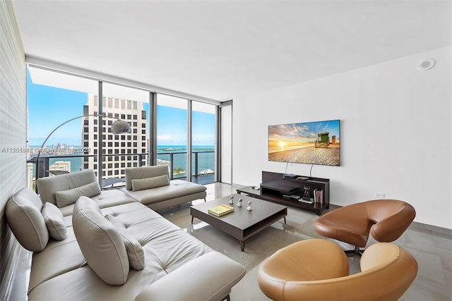 living room featuring a water view and expansive windows