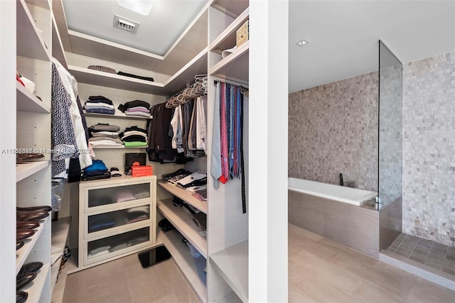 spacious closet featuring tile flooring