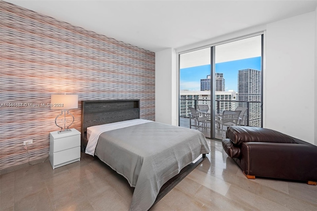 tiled bedroom with access to exterior and a wall of windows