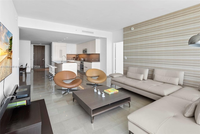 tiled living room featuring sink