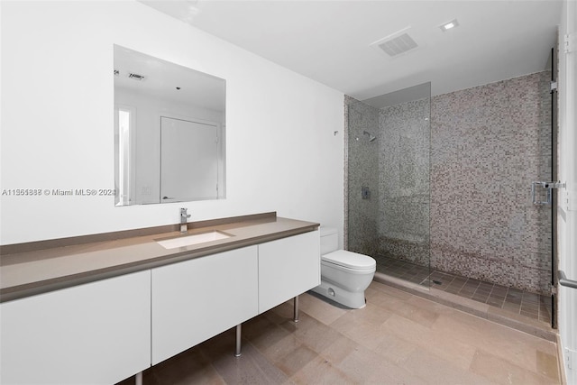 bathroom featuring an enclosed shower, toilet, tile floors, and vanity