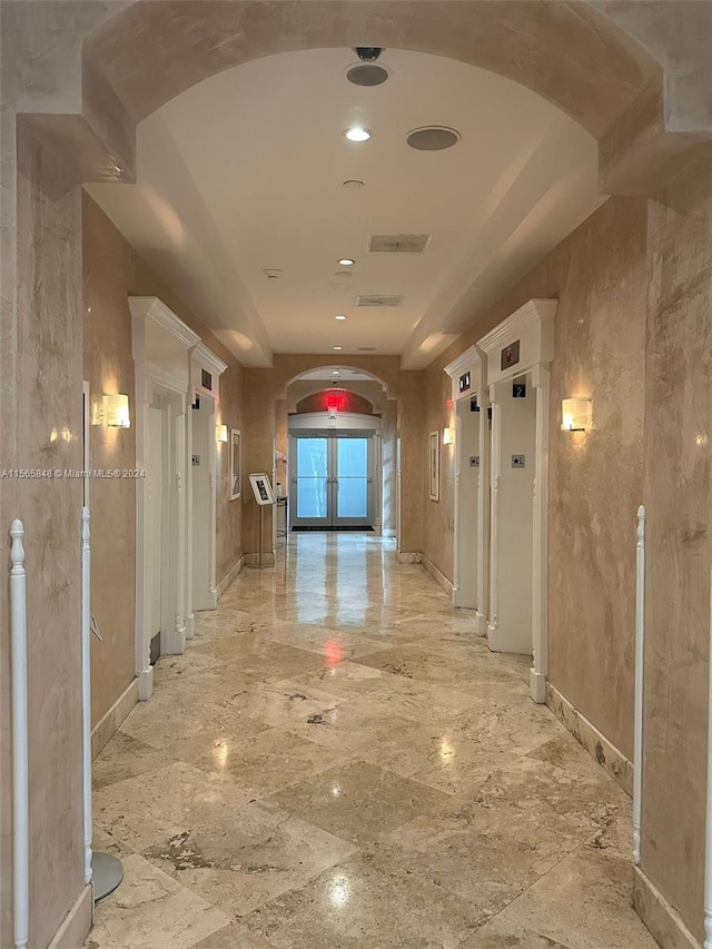 corridor with elevator and light tile flooring