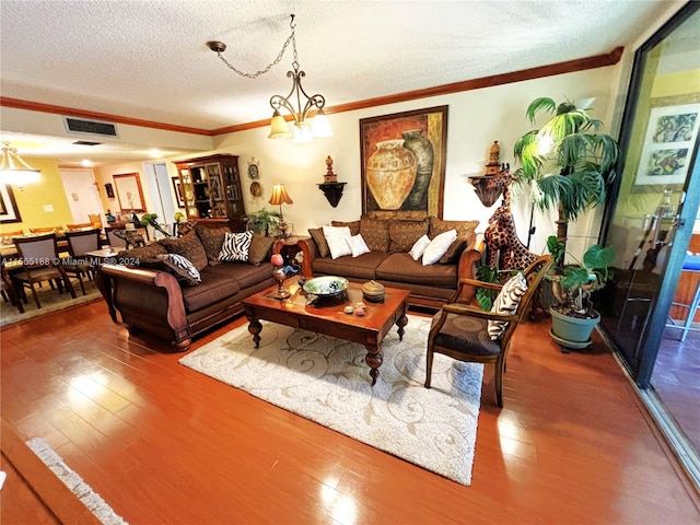 living room featuring hardwood / wood-style floors, a chandelier, and a textured ceiling