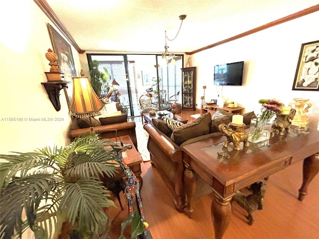 living room with crown molding, an inviting chandelier, wood-type flooring, expansive windows, and a textured ceiling