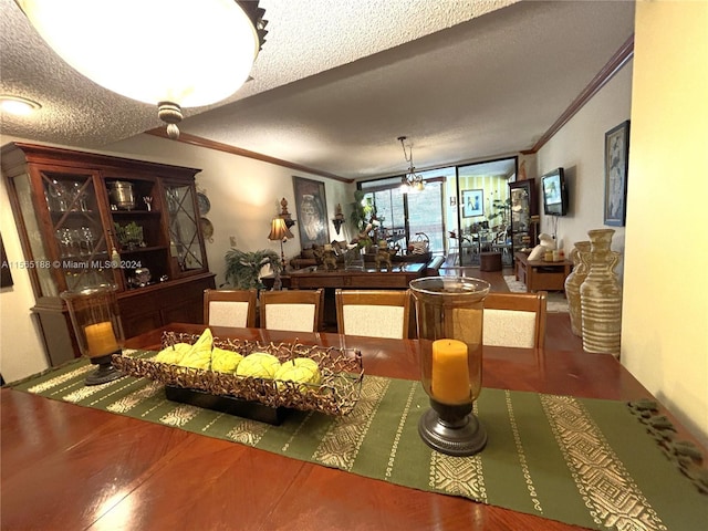 dining room featuring crown molding, wood-type flooring, a chandelier, and a textured ceiling