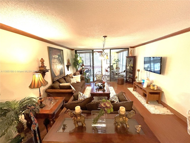 living room with a notable chandelier, crown molding, hardwood / wood-style floors, and a textured ceiling