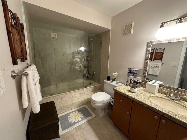 full bathroom with enclosed tub / shower combo, vanity, tile patterned flooring, and toilet