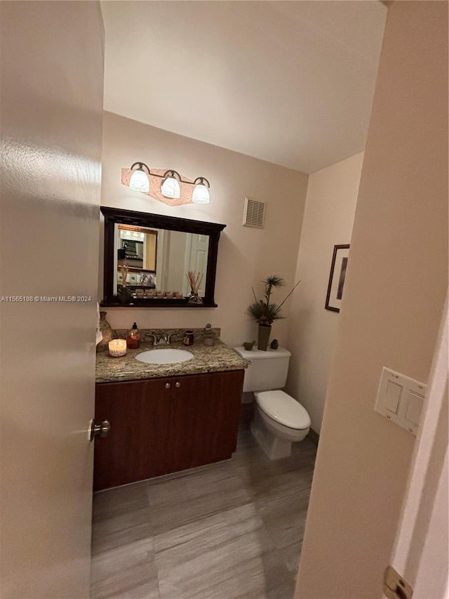 bathroom with vanity and toilet