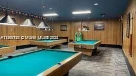 playroom with wood walls and billiards