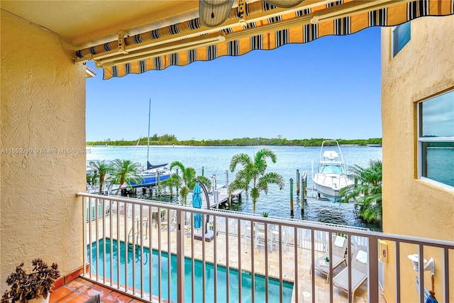 balcony featuring a dock and a water view