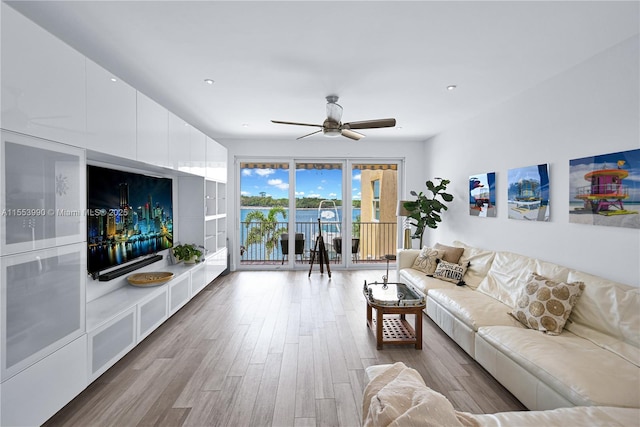 living room featuring hardwood / wood-style floors and ceiling fan