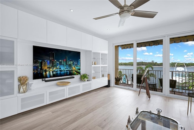 living room featuring ceiling fan and light hardwood / wood-style floors