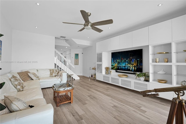 living room with ceiling fan and light hardwood / wood-style flooring