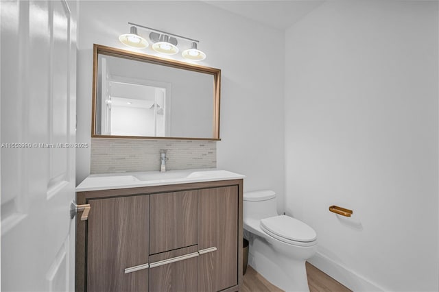4234 N Ocean Dr, Hollywood, FL 33019 - half bath featuring vanity, wood finished floors, and decorative backsplash
