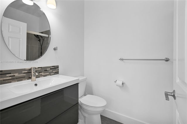 bathroom with vanity, decorative backsplash, and toilet