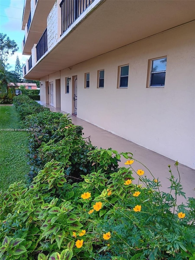 view of exterior entry with a balcony