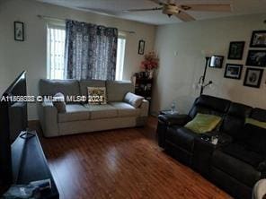 living room with ceiling fan and dark hardwood / wood-style floors