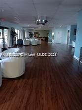 unfurnished living room with dark wood-type flooring