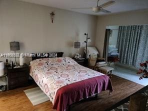 bedroom featuring ceiling fan and hardwood / wood-style floors