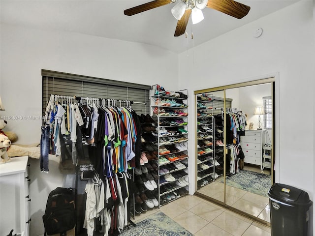 walk in closet with ceiling fan and light tile floors