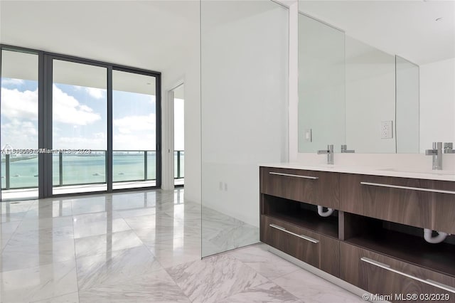 bathroom featuring a wall of windows, tile flooring, oversized vanity, and a water view