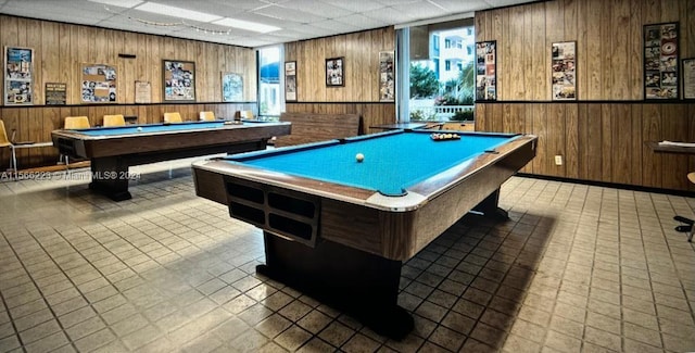 game room with a paneled ceiling, tile floors, and billiards