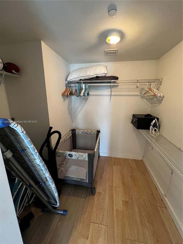 spacious closet with light hardwood / wood-style flooring