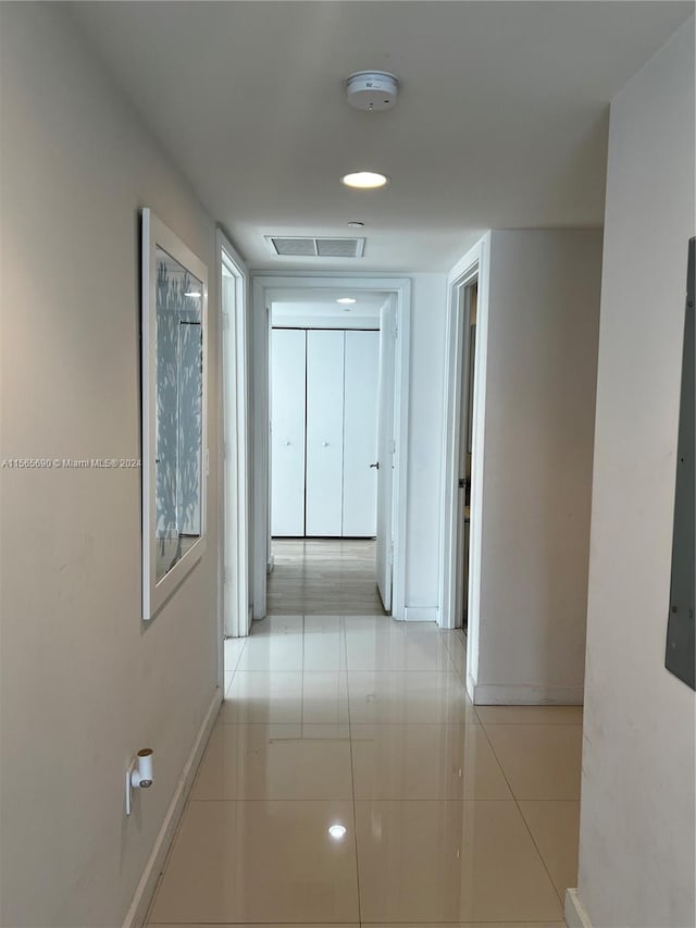 hallway featuring light tile flooring