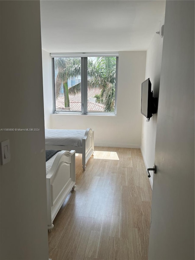 bedroom with light wood-type flooring