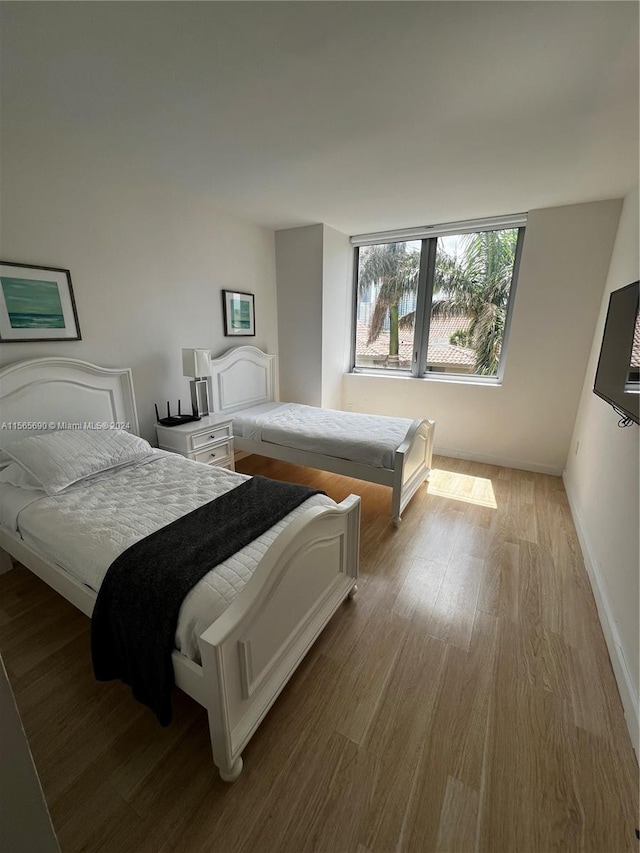 bedroom with hardwood / wood-style floors